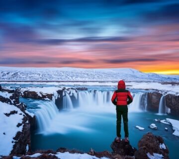 Godafoss waterfall sunset winter iceland guy red jacket looks godafoss waterfall 335224 673 360x320